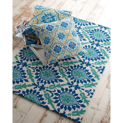 Green and blue rug and pillows