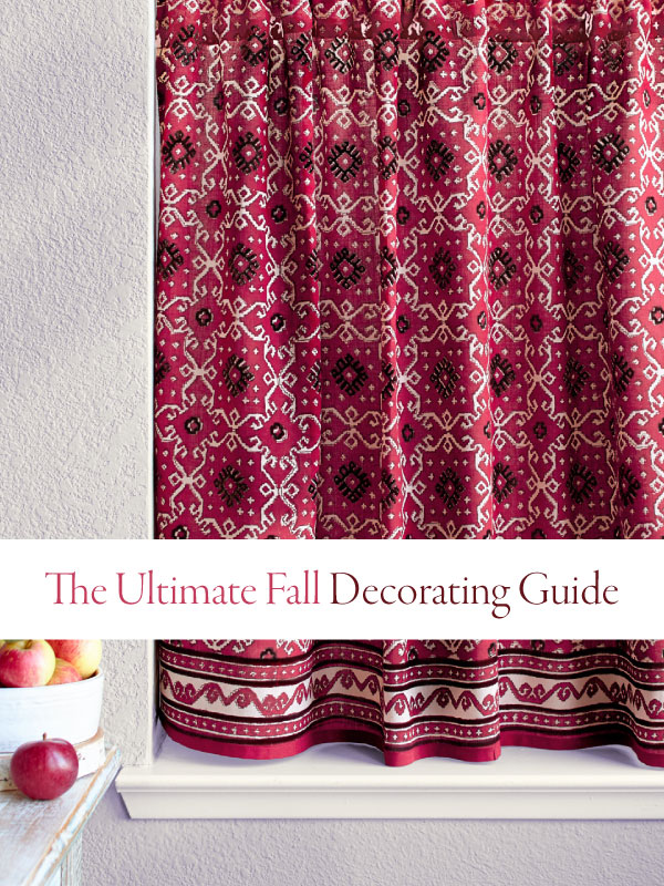 ultimate fall decorating guide banner over red curtains and near a bowl of apples