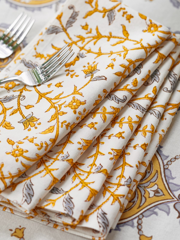 yellow and white cloth napkins with a botanical pattern
