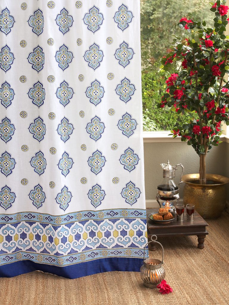white Moroccan curtains with quatrefoil patttern, blue, and green
