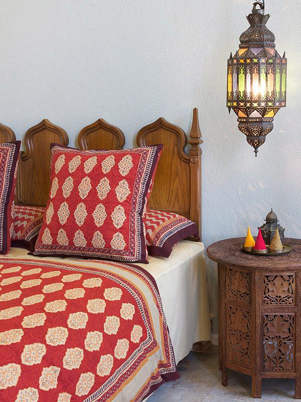 red moroccan pillows are perfect in this tropical house