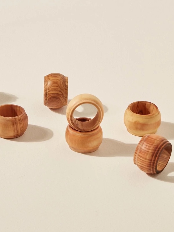 Photograph of olive wood napkin rings to complement an orange fall tablecloth