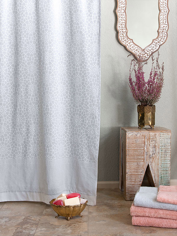 white fabric shower curtain in a moroccan pattern 