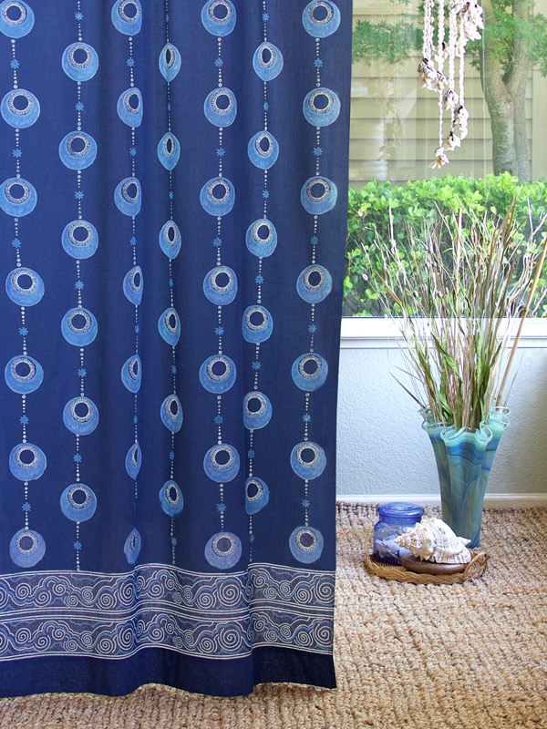 Blue curtains with a 1950s Hawaiian pattern are great for summer decor.