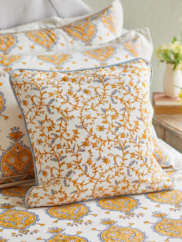 yellow and grey and white throw pillow with vine pattern like forsythia