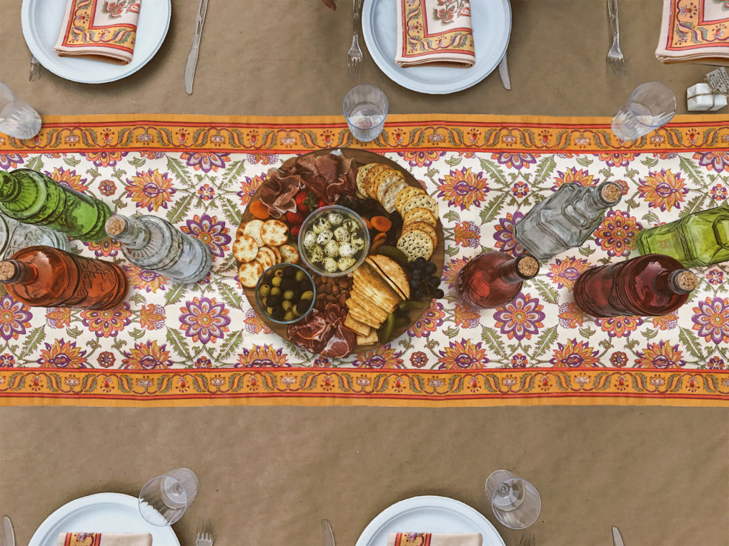 orange fall and Thanksgiving table runner with platters and simple dishes