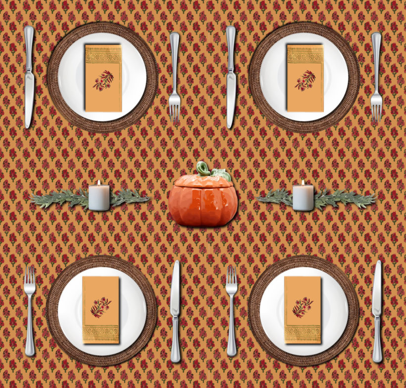 red and orange tablecloth for Thanksgiving with pumpkin tureen, garland, candles