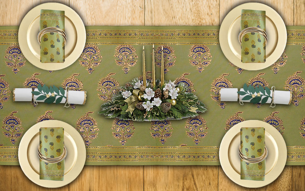 A green Christmas table runner anchors an elegant Christmas table setting in gold and green