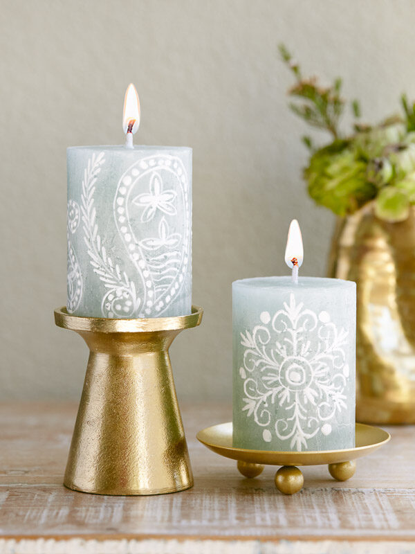 Hand painted sage green candles with white lacy details to complement an elegant Christmas tablecloth