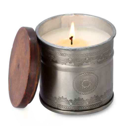 a handmade candle in an etched iron pot used for a romantic bath