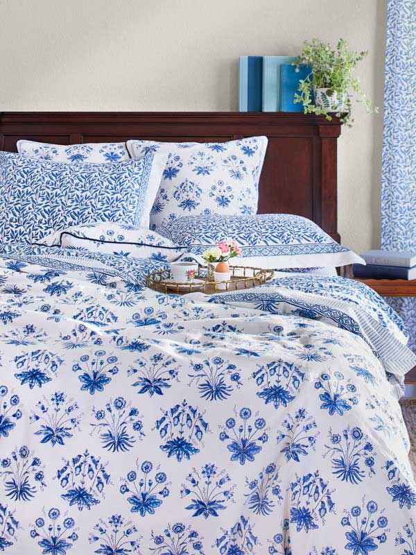 blue and white bedding with floral pattern
