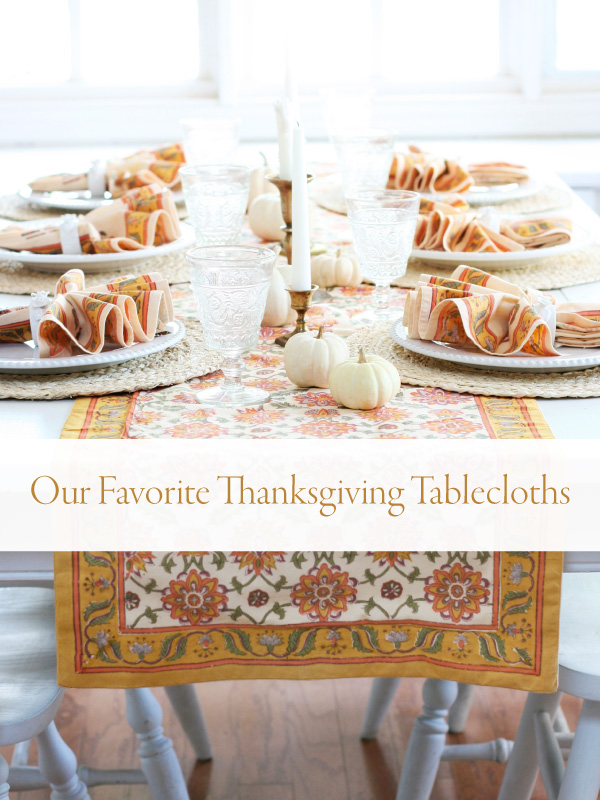 orange tablecloth and white pumpkins with banner that reads Our Favorite Thanksgiving Tablecloths