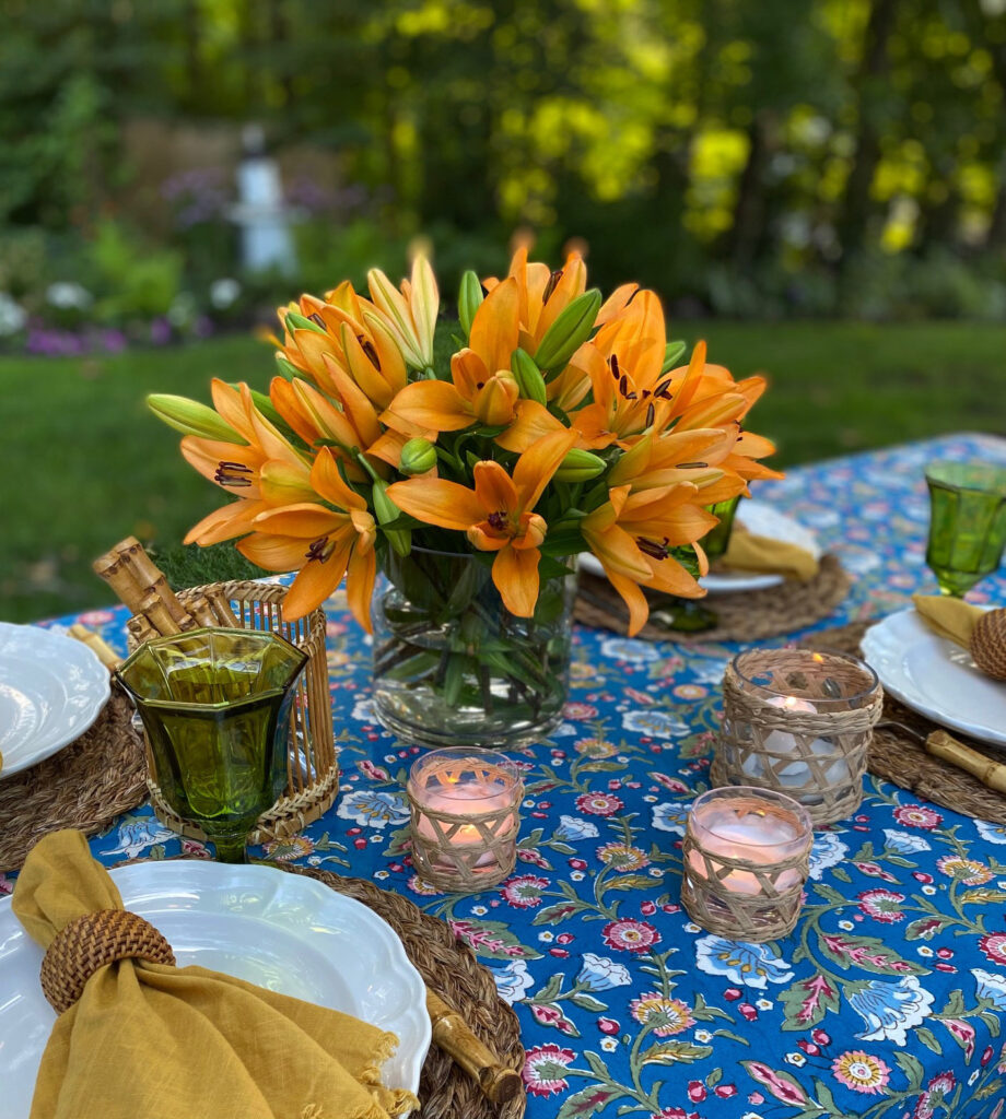blue floral tablecloth with tiger lilies and boho table decor
