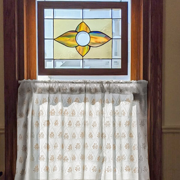 gold and white boho curtains, cafe curtains under stained glass window