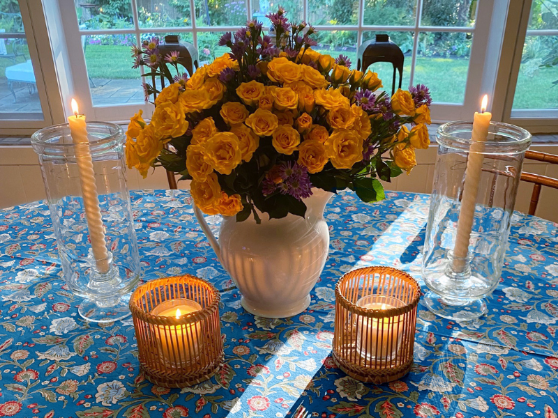 hygge dining table with flowers tablelcoth and candles