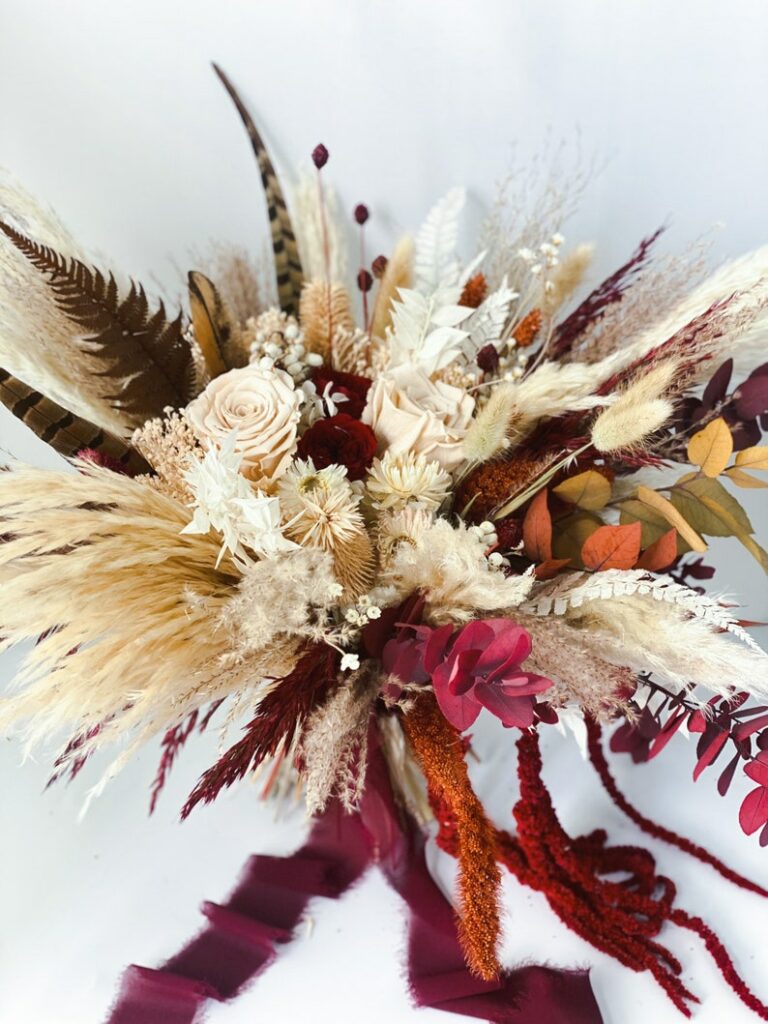 pampas grass and feather centerpiece in red and cream