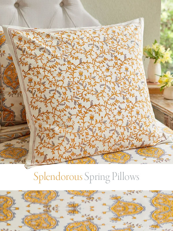 yellow floral throw pillow on a bed with a botanical print and sign that says "splendorous spring pillows"
