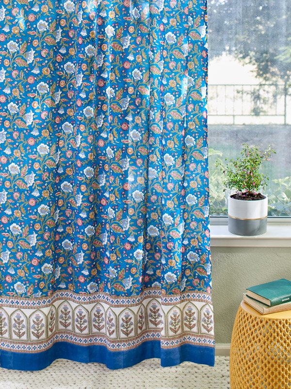 cottage curtains with floral pattern on blue background