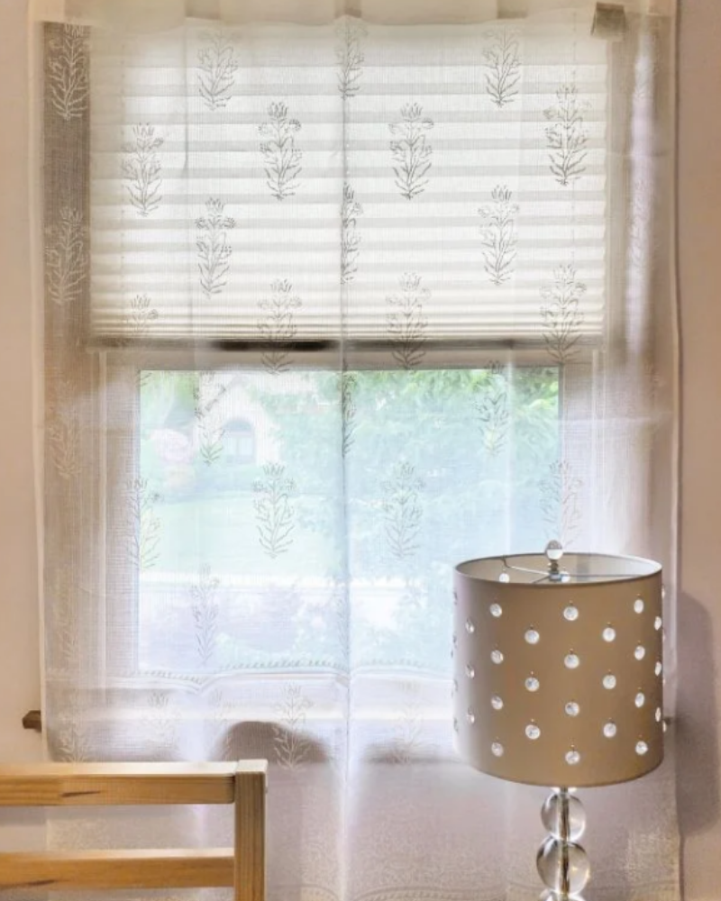 white sheer curtain with floral pattern