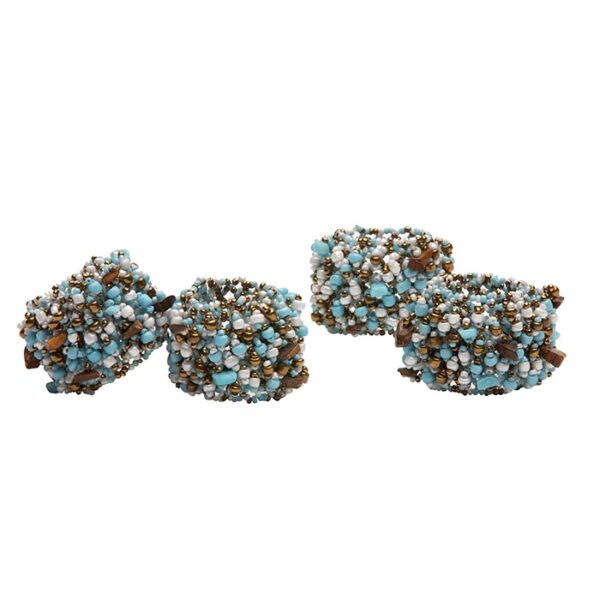 A set of four beaded napkin rings made of turquoise, brass, and brown beads positioned against a white background