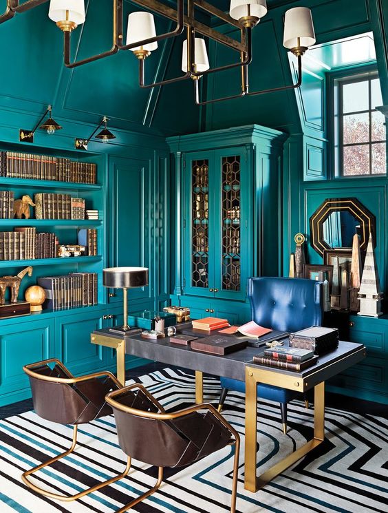 Office with teal walls and golden accents throughout