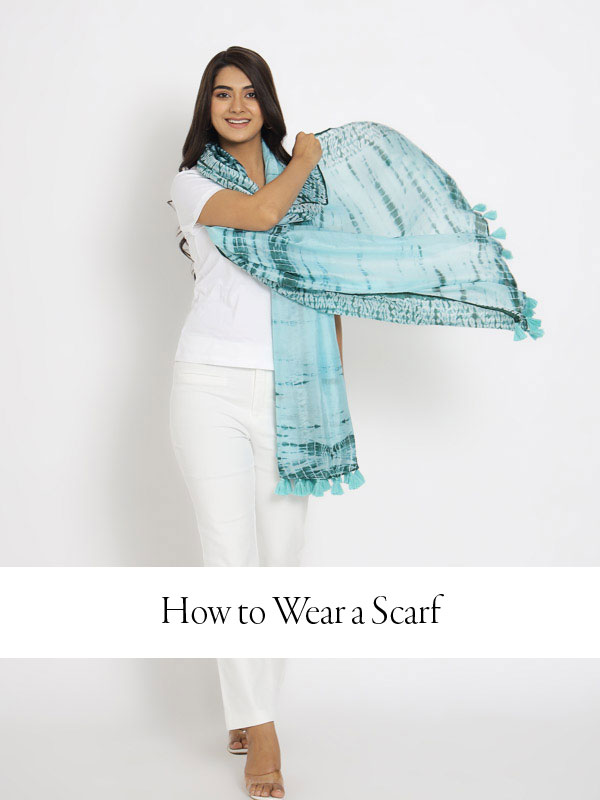 how to wear a scarf hero image of model wearing an ice blue scarf