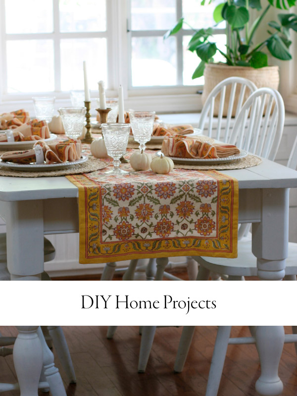 A set dining table with an orange table runner and overlaid text that reads DIY home projects