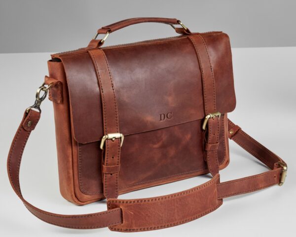Photograph of a brown leather briefcase with a shoulder strap
