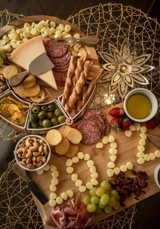 Photograph of a new year's themed charcuterie plate with cheese slices spelling out "2022"