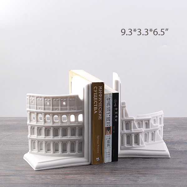 Pair of white sandstone Rome Coliseum bookends with a handful of books in betewen