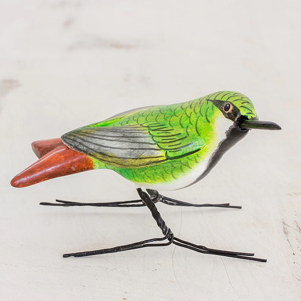 Photograph of a handmade green and red hummingbird figure