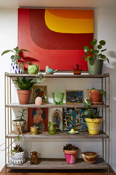 Photograph of a colorful wall shelf with jewel tone colorful shelf decor