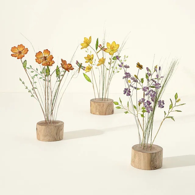 Three wildflower synthetic bouquets in wooden stands