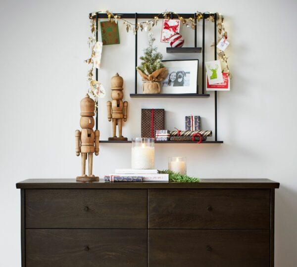 Photograph of a seasonal wall shelf display atop a wooden dresser