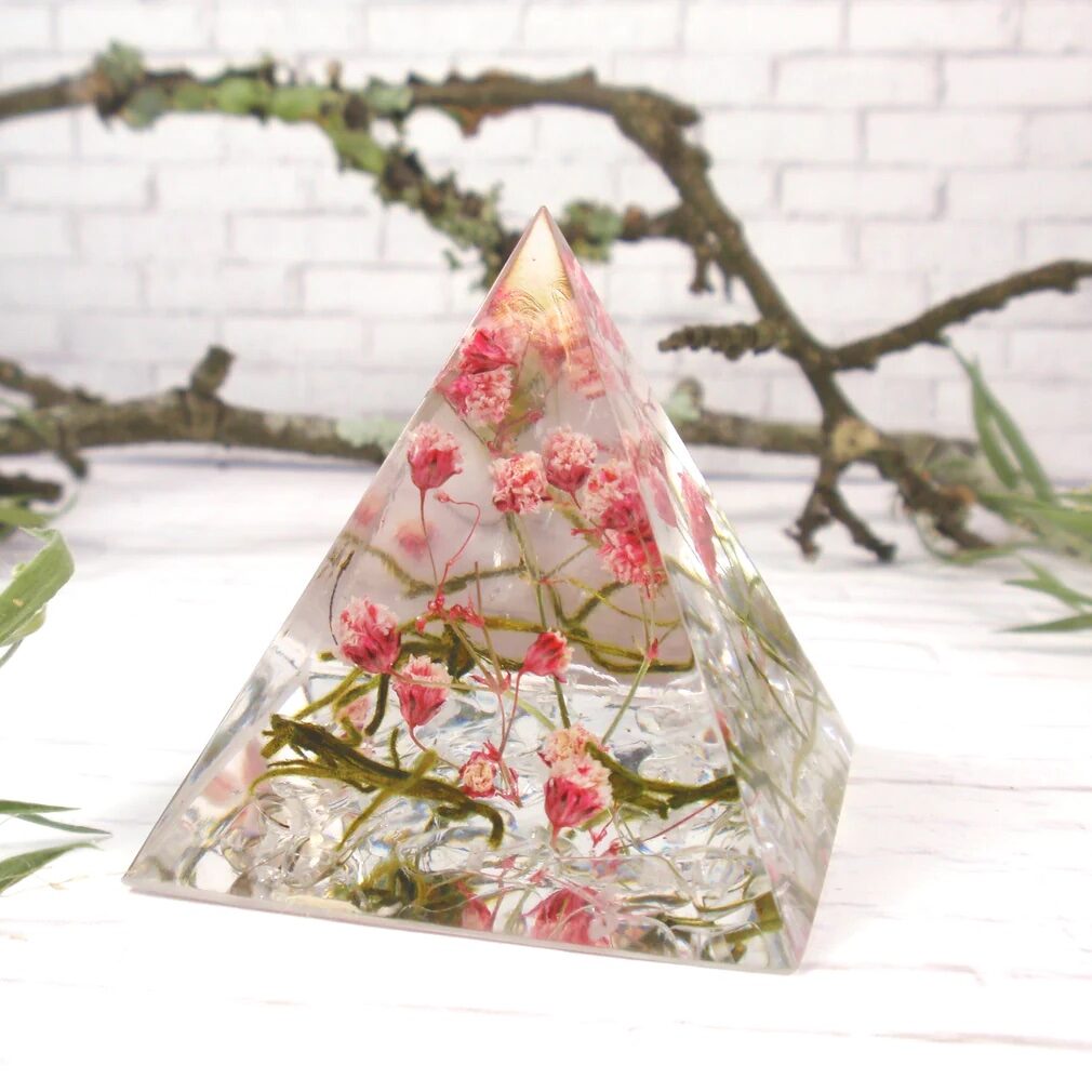 Pyramid resin paperweight with pink wildflowers and green foliage inside
