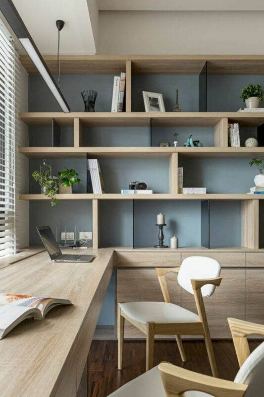 Shelf decor in a monochromatic office with wood furnishings and a light blue wall