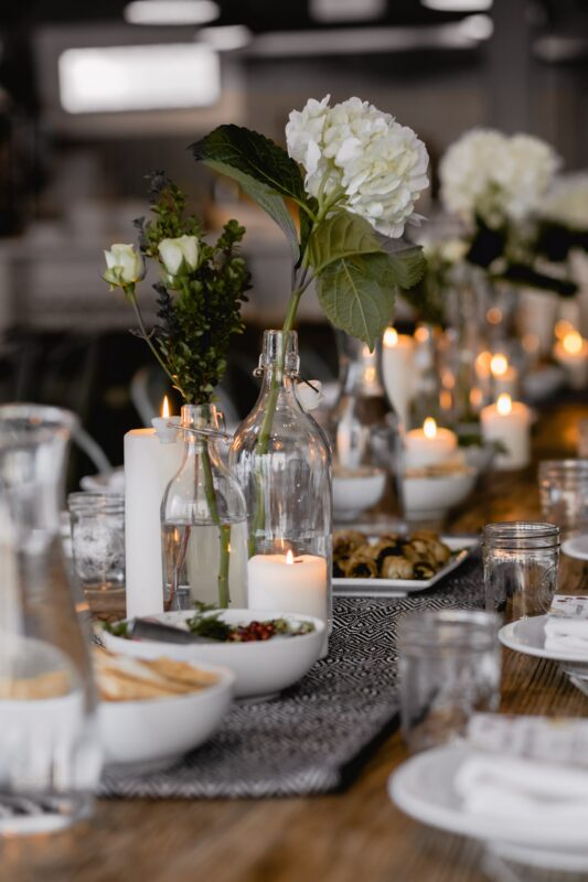 Engagement party ideas for table centerpieces using vases, flowers, and candles