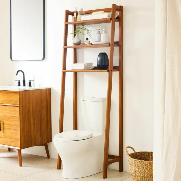 Photograph of a bathroom with an over-the-toilet shelf filled with clean and modern shelf decor