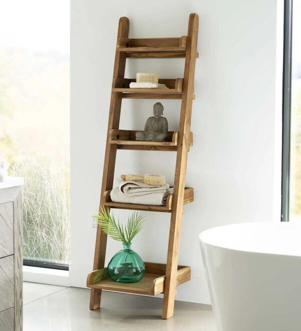 Photograph of wooden ladder style bathroom shelf with zen-inspired shelf decor in a white bathroom