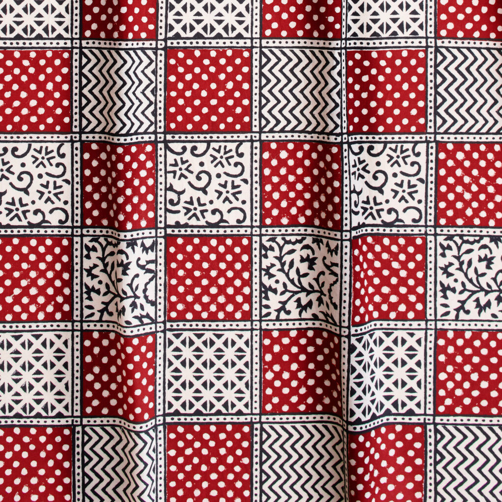 Image of a Christmas fabric with foliage, polka dots, and stripes for a festive look