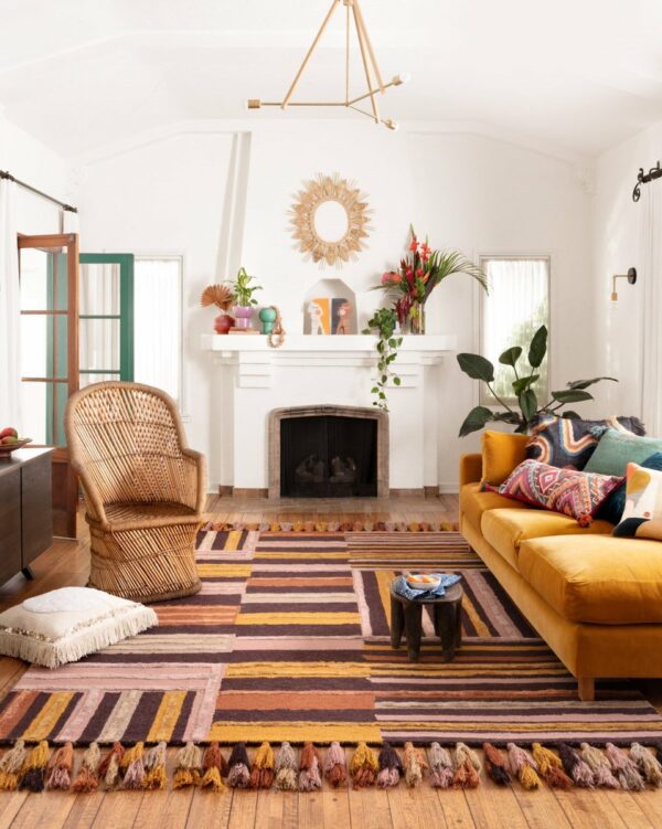 Photograph of a modern bohemian style living space using warm colors and an open plan layout