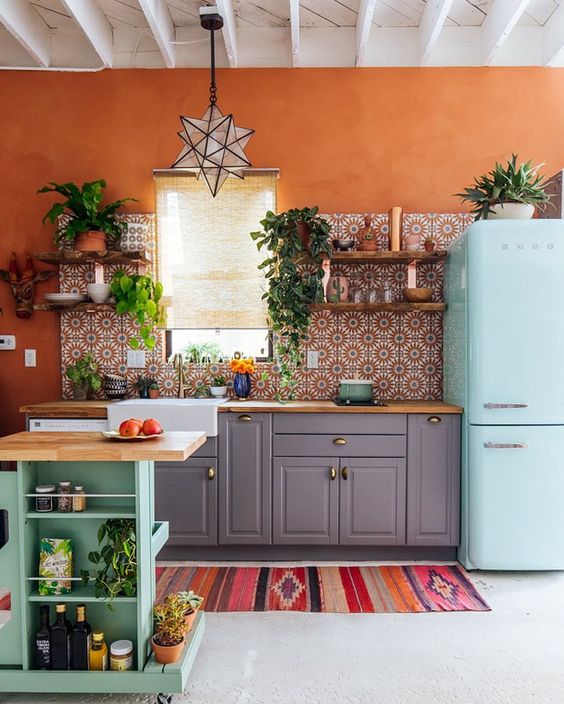 Example of a modern bohemian style kitchen using mosaic tiles and burnt orange