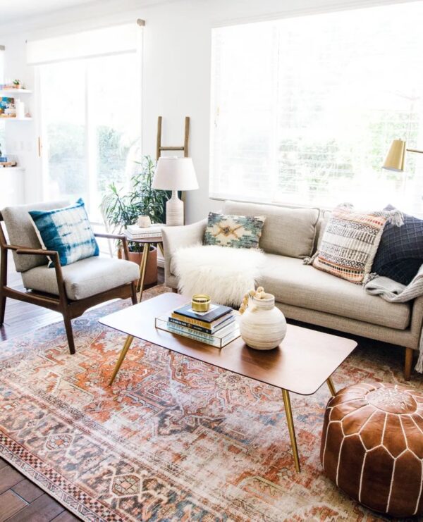Photograph of a modern bohemian style living room using mid-century modern furniture and traditional patterns
