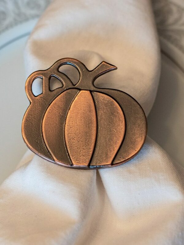 Photograph of Thanksgiving napkin ring featuring a metal pumpkin figurine