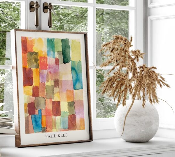 Photograph of a colorful framed artwork on a neutral white window sill