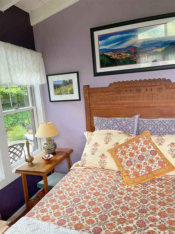 Photograph of orange bedding and purple pillow accents to beat the winter blues