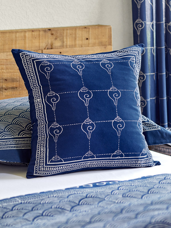 How to style a calming kid's room with linens using a seashell pattern pillow
