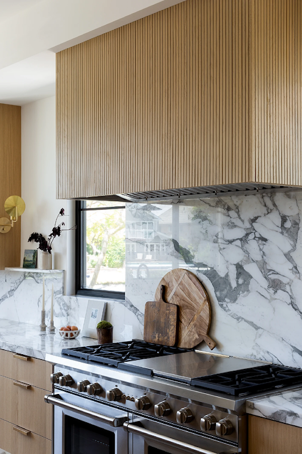 A picture of a kitchen showcasing reeded wood cabinets, one of the top 2024 kitchen trends of the year
