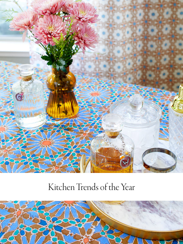 Photograph of a table with a serving tray and beverage station set on a boho Moroccan tablecloth